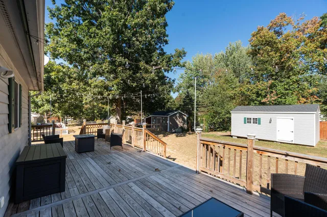 a view of deck with furniture and trees
