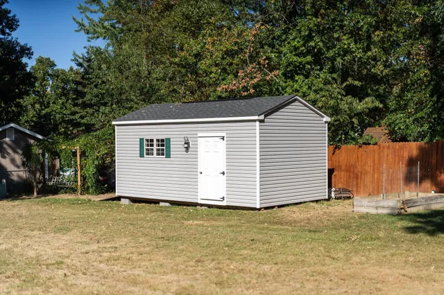 a backyard of a house with shaded area