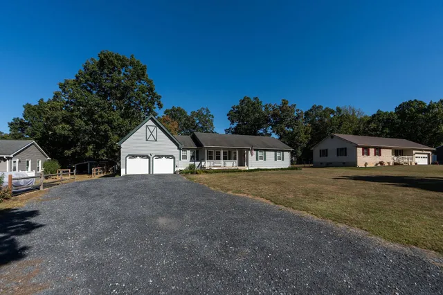 a front view of a house with a garden and yard