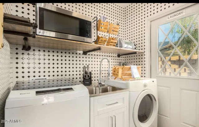 a bathroom with a granite countertop sink a mirror and shower curtain