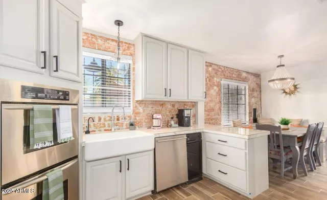 a kitchen with sink cabinets and window