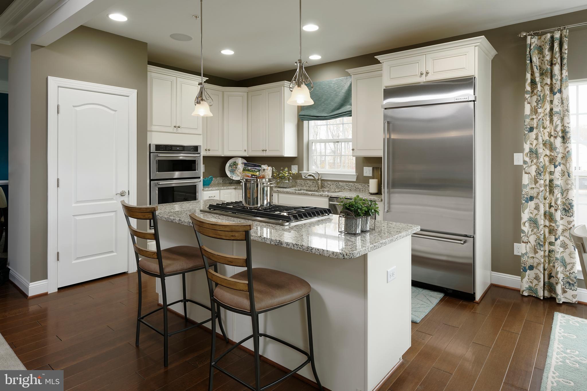 8600 Hines Circle Laurel, MD 20723 - Photo 3 of 9 a kitchen with kitchen island a counter space a sink appliances and cabinets