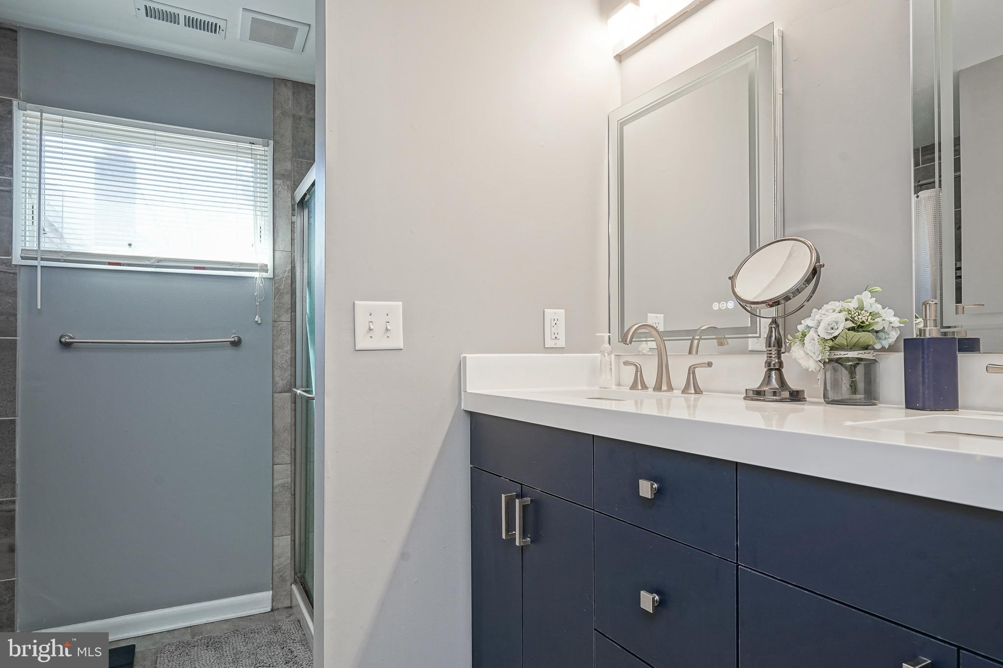 32 Strathmore Drive Cherry Hill, NJ 08003 - Photo 20 of 33 a bathroom with a double vanity sink and a mirror