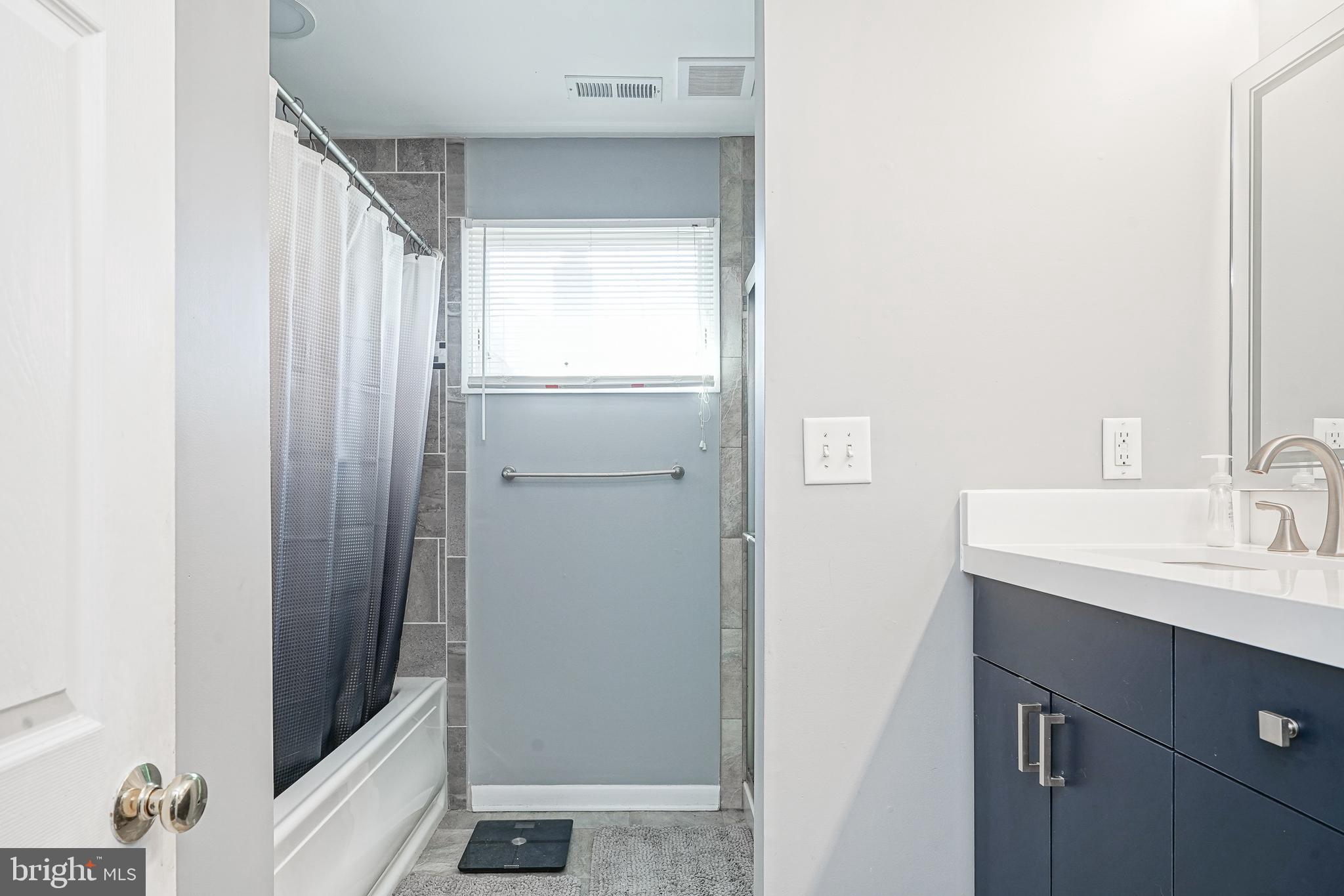 32 Strathmore Drive Cherry Hill, NJ 08003 - Photo 21 of 33 a bathroom with a sink a mirror and a shower