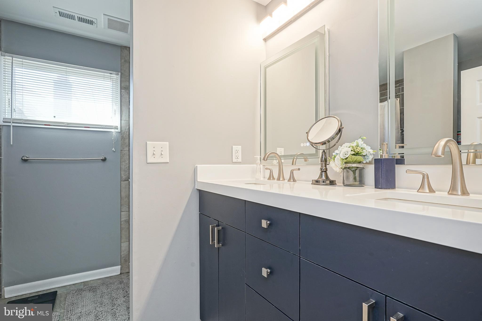 32 Strathmore Drive Cherry Hill, NJ 08003 - Photo 22 of 33 a bathroom with a double vanity sink and a mirror
