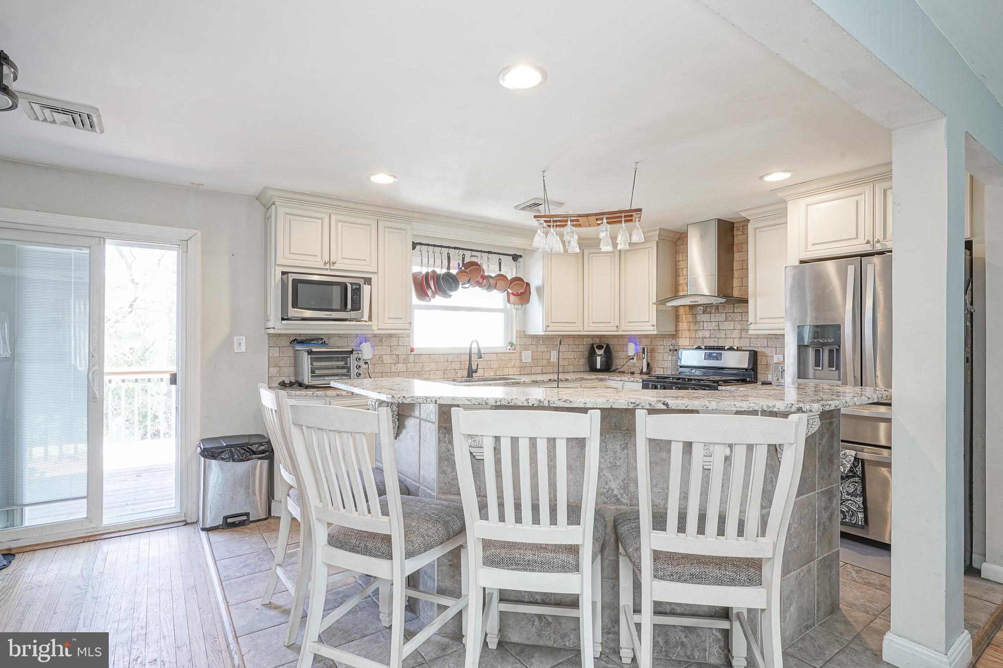 32 Strathmore Drive Cherry Hill, NJ 08003 - Photo 7 of 33 a kitchen with stainless steel appliances granite countertop a white cabinets and a refrigerator