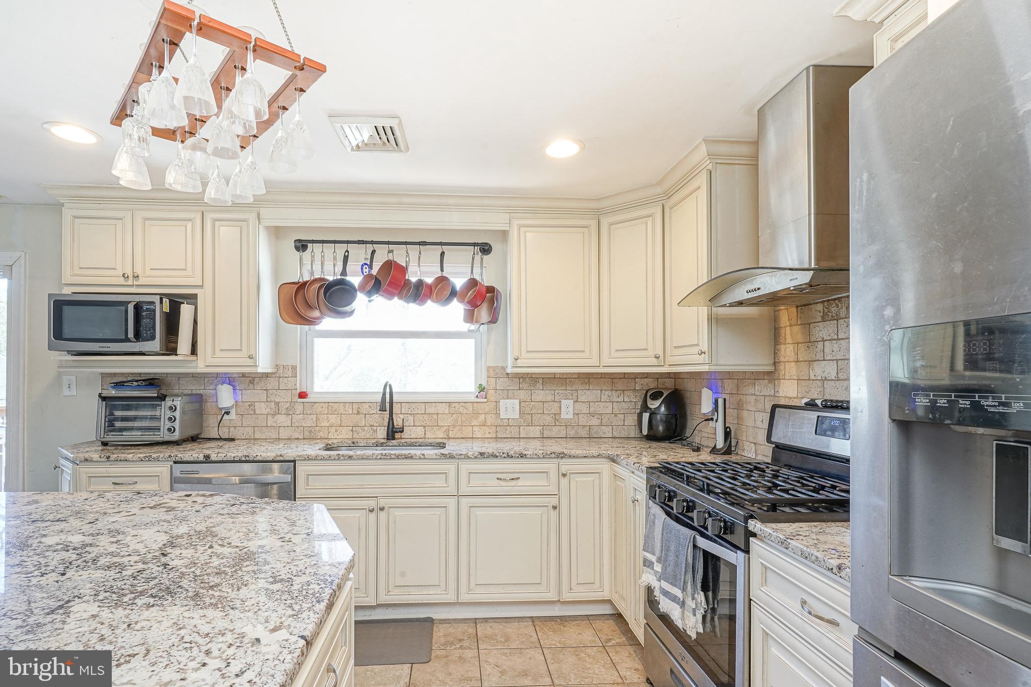 32 Strathmore Drive Cherry Hill, NJ 08003 - Photo 9 of 33 a kitchen with stainless steel appliances granite countertop a stove sink and cabinets
