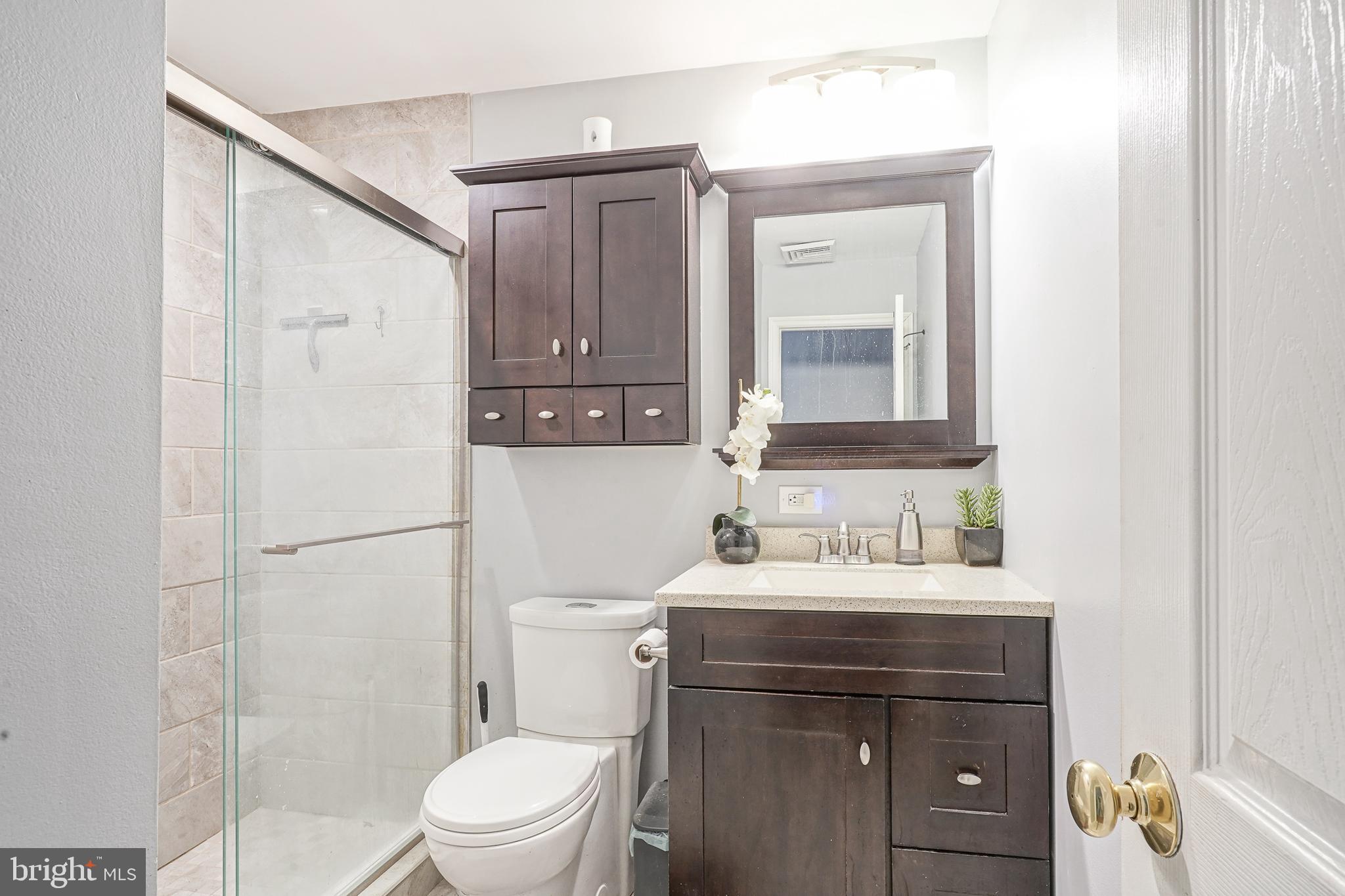 32 Strathmore Drive Cherry Hill, NJ 08003 - Photo 10 of 33 a bathroom with a toilet sink vanity and mirror