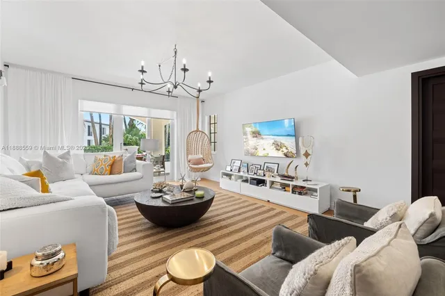 a living room with furniture a rug and a chandelier