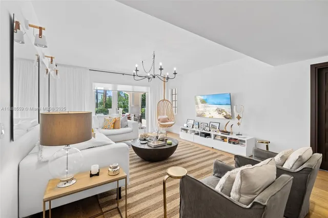 a living room with furniture and a chandelier