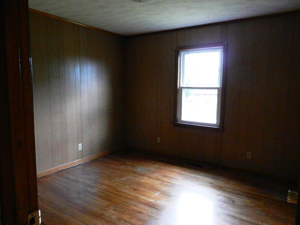630 Power Dam Road Rocky Mount, VA 24151 - Photo 8 of 12 an empty room with wooden floor and windows