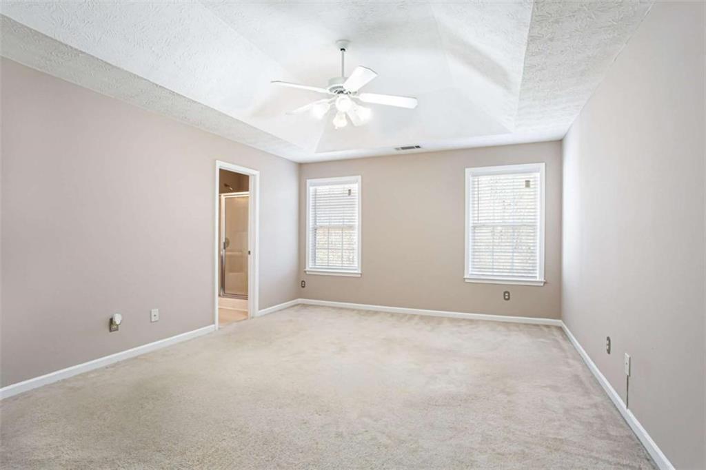 3721 Bogan Mill Road Northeast Buford, GA 30519 - Photo 23 of 58 an empty room with windows and fan