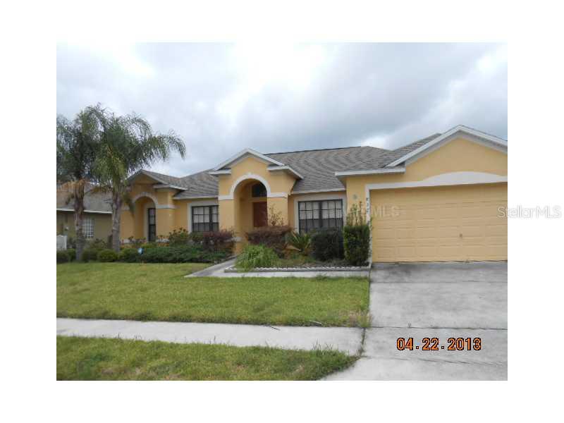 837 Coventry Road Davenport, FL 33897 - Photo 1 of 1 a view of a white house with a yard and potted plants