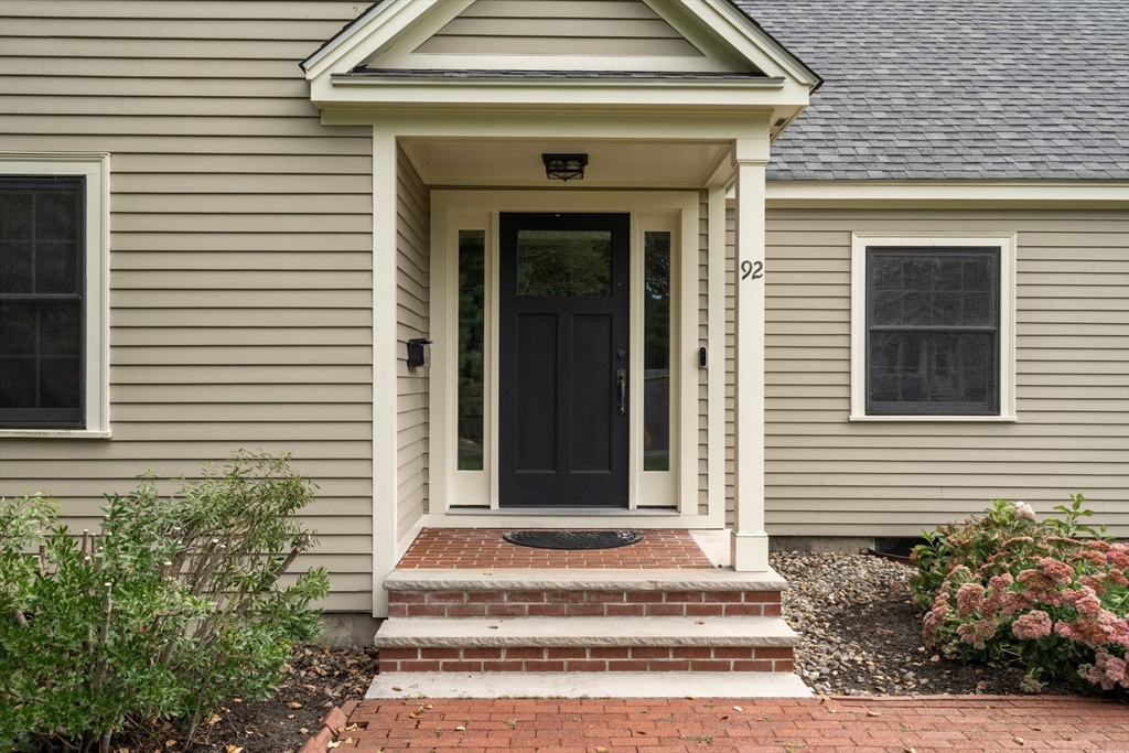 92 Abbot Street Andover, MA 01810 - Photo 3 of 35 a front view of a house with potted plants