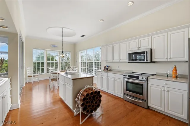 a kitchen with a stove sink and cabinets