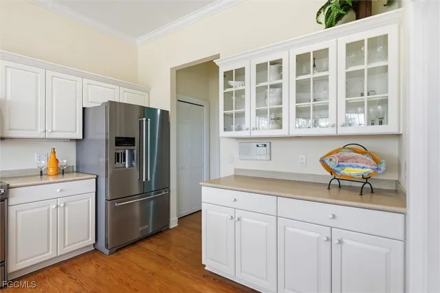 a kitchen with stainless steel appliances granite countertop a refrigerator and a sink