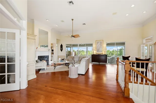 a living room with fireplace furniture and a wooden floor