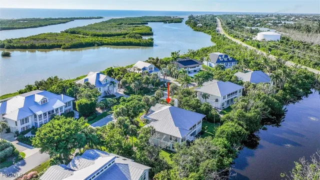an aerial view of a house with a garden and lake view