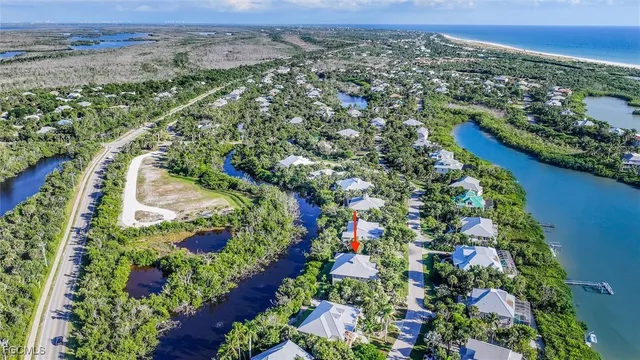 an aerial view of residential houses with outdoor space and trees