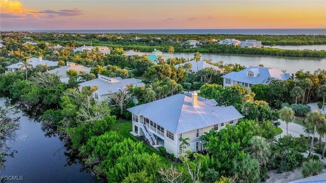 an aerial view of a house with a lake view
