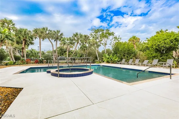 a view of a swimming pool with an outdoor space and seating area