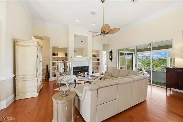 a view of a livingroom with furniture wooden floor a chandelier