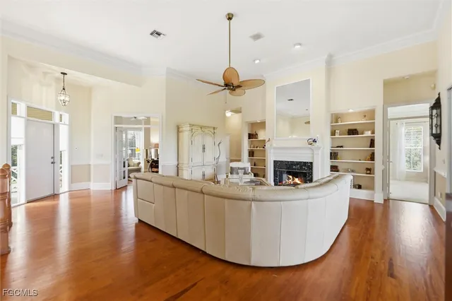 a living room with fireplace furniture and a wooden floor