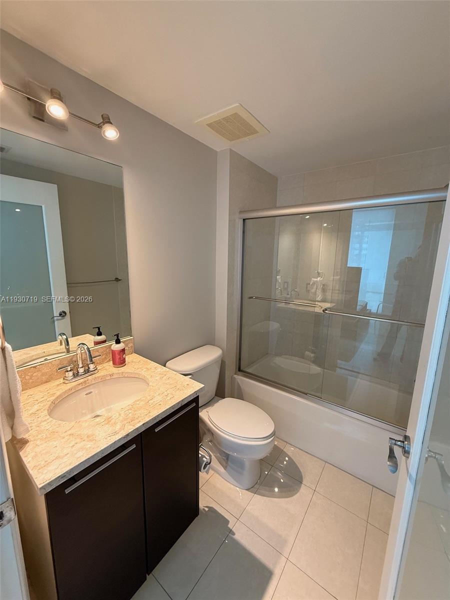 480 Northeast 30th Street, Unit 1505 Miami, FL 33137 - Photo 13 of 21 a bathroom with a sink a toilet and shower