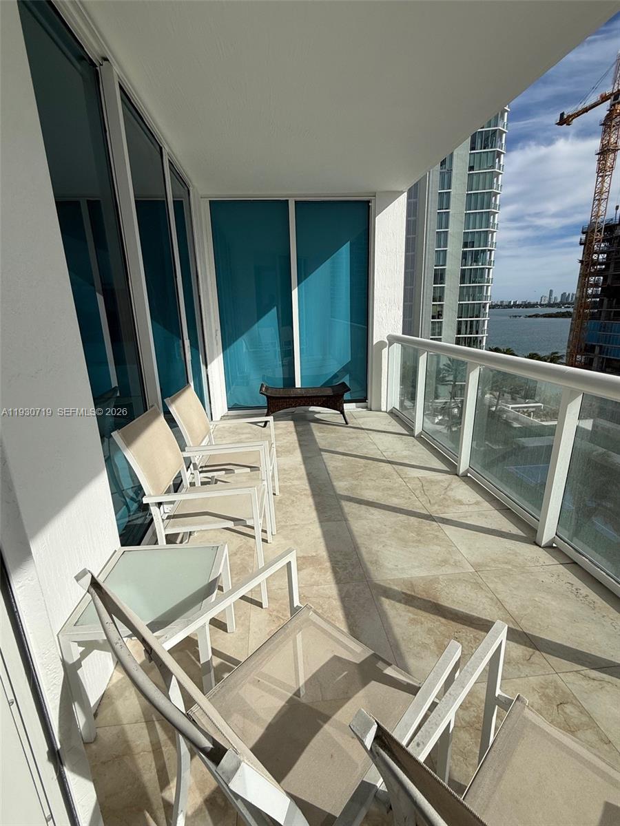480 Northeast 30th Street, Unit 1505 Miami, FL 33137 - Photo 15 of 21 a view of a patio with a table and chairs