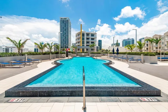 a swimming pool with outdoor seating and yard