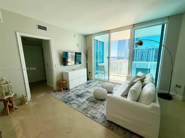 a living room with furniture and a flat screen tv