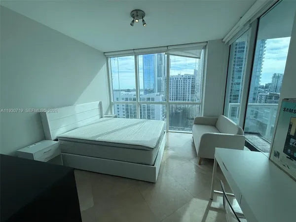 a bedroom with a bed and a balcony