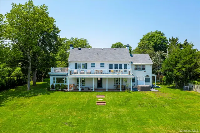 a view of a house with a big yard and large trees