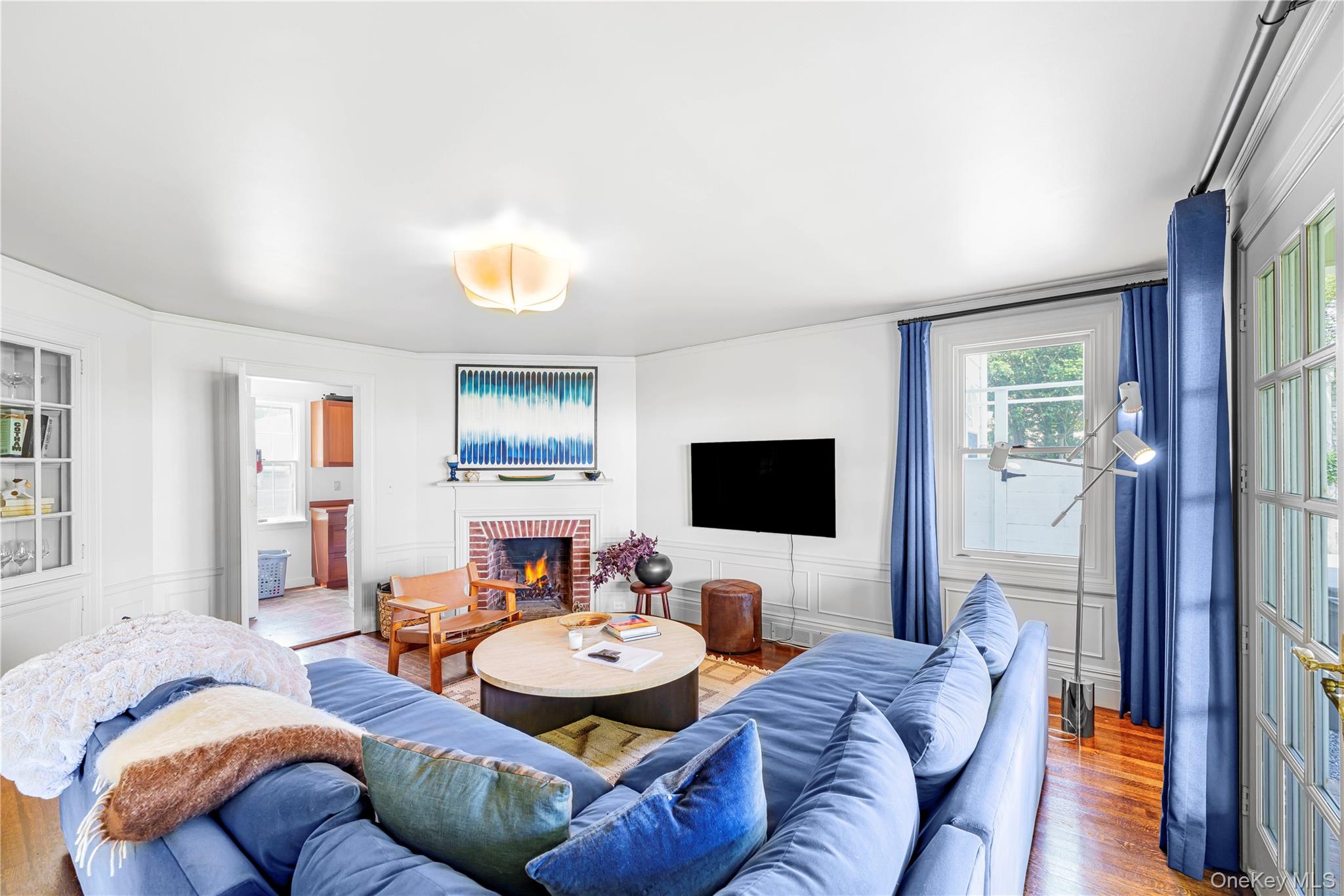 5 Thorn Hedge Road Bellport, NY 11713 - Photo 13 of 42 a living room with furniture and a flat screen tv