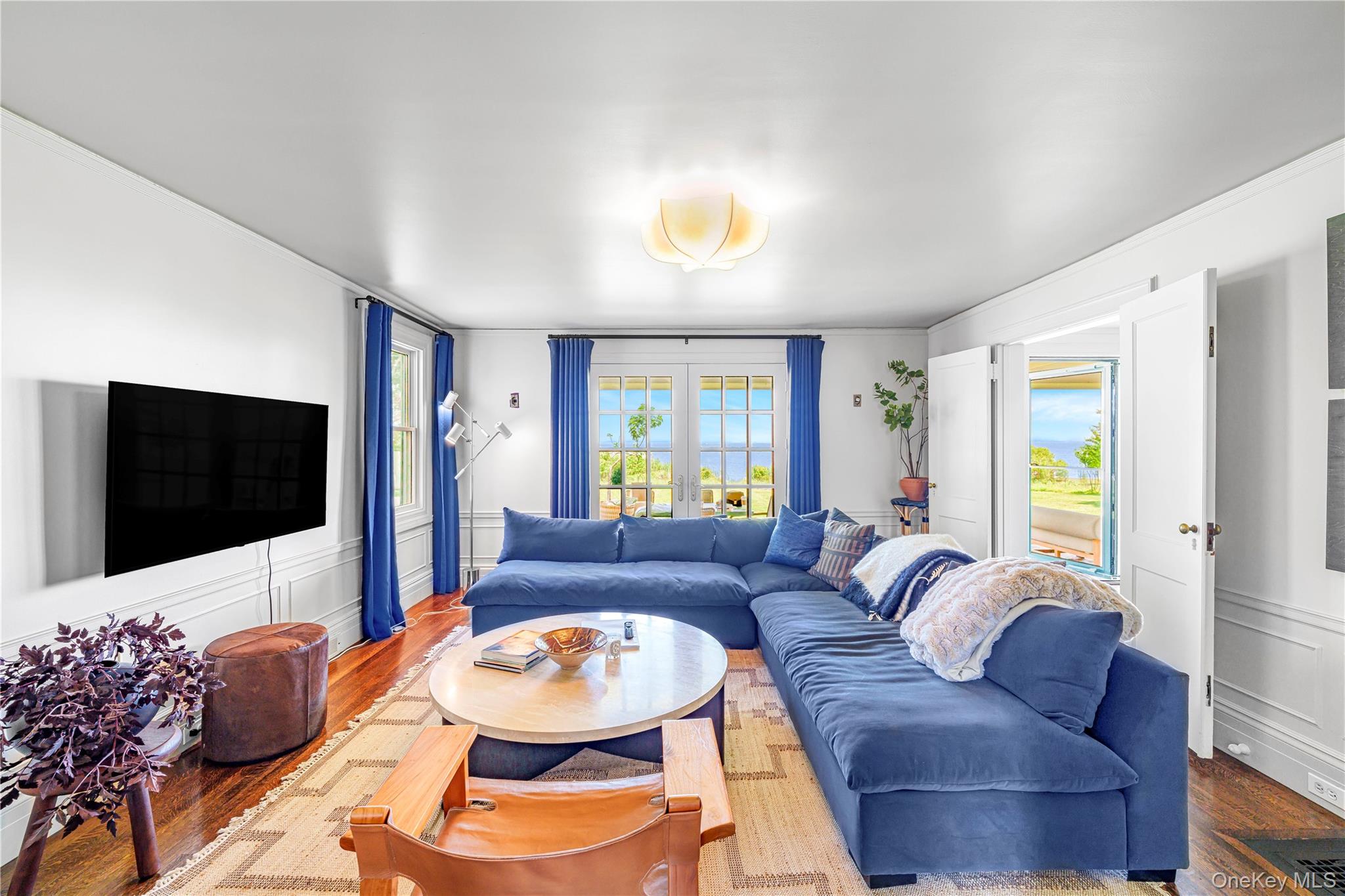 5 Thorn Hedge Road Bellport, NY 11713 - Photo 14 of 42 a living room with furniture and a flat screen tv