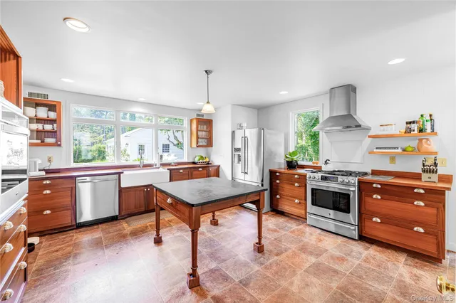 a kitchen with stainless steel appliances granite countertop a refrigerator and a sink