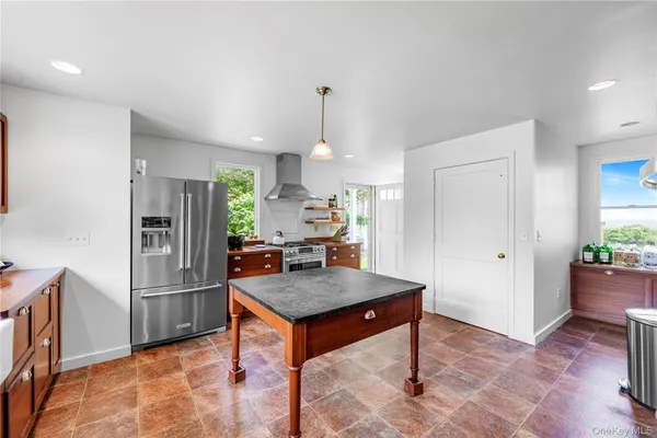 a kitchen with stainless steel appliances granite countertop a sink counter space cabinets and a window