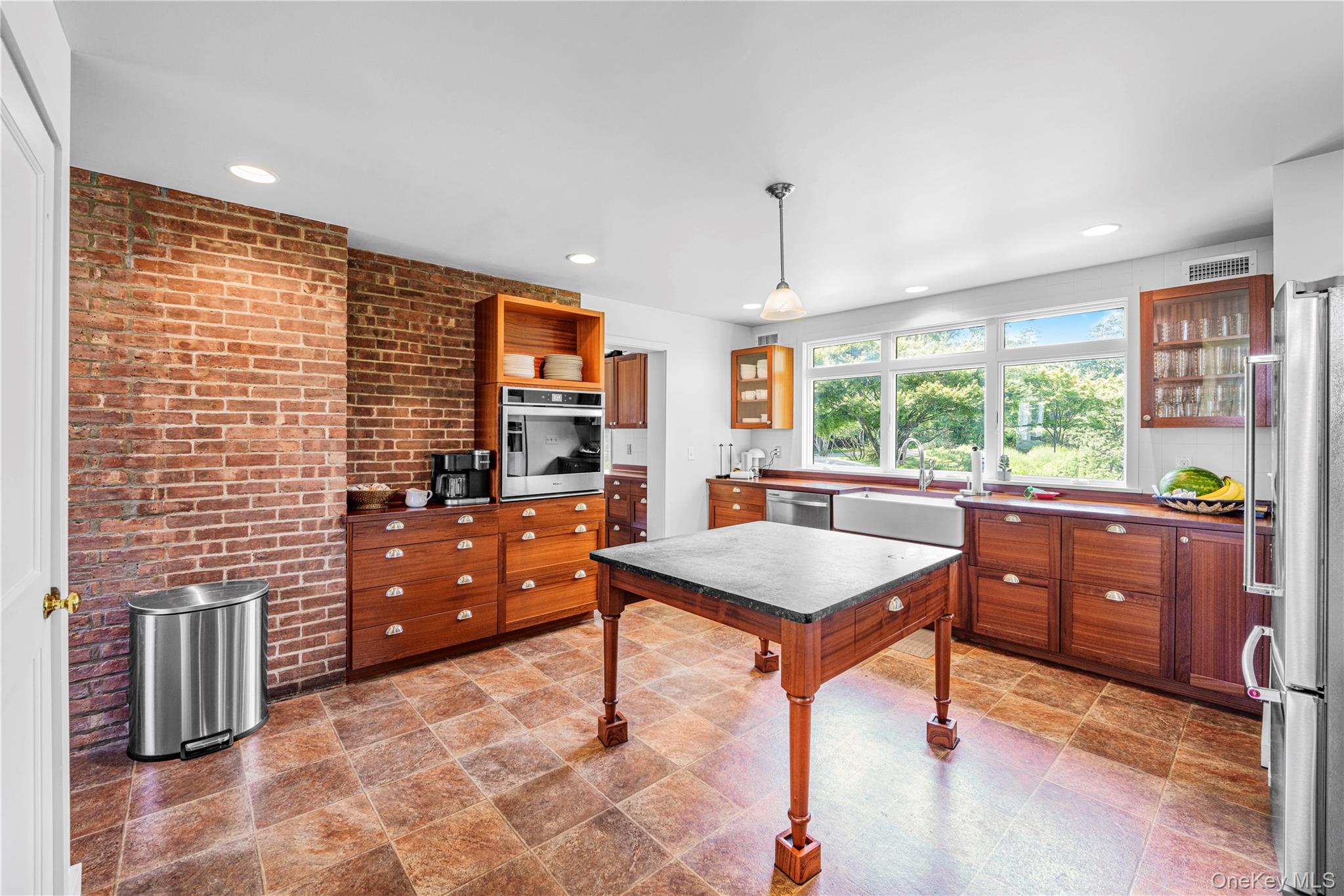 5 Thorn Hedge Road Bellport, NY 11713 - Photo 18 of 42 a kitchen with stainless steel appliances granite countertop a sink counter space cabinets and a window