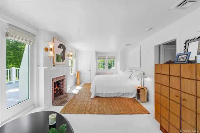 a living room with furniture a fireplace and a large window