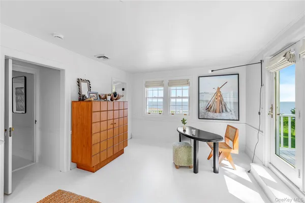 a view of a balcony with table and chairs with wooden floor and fence