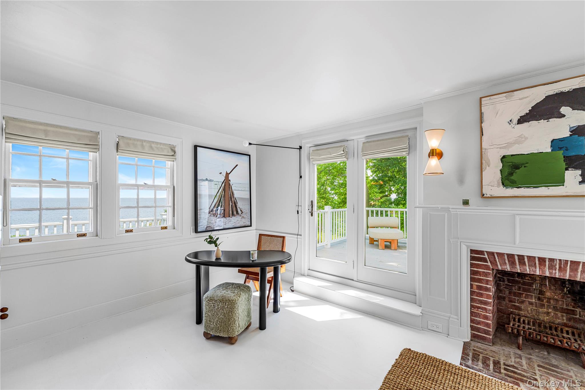 5 Thorn Hedge Road Bellport, NY 11713 - Photo 21 of 42 a living room with furniture a fireplace and a large window