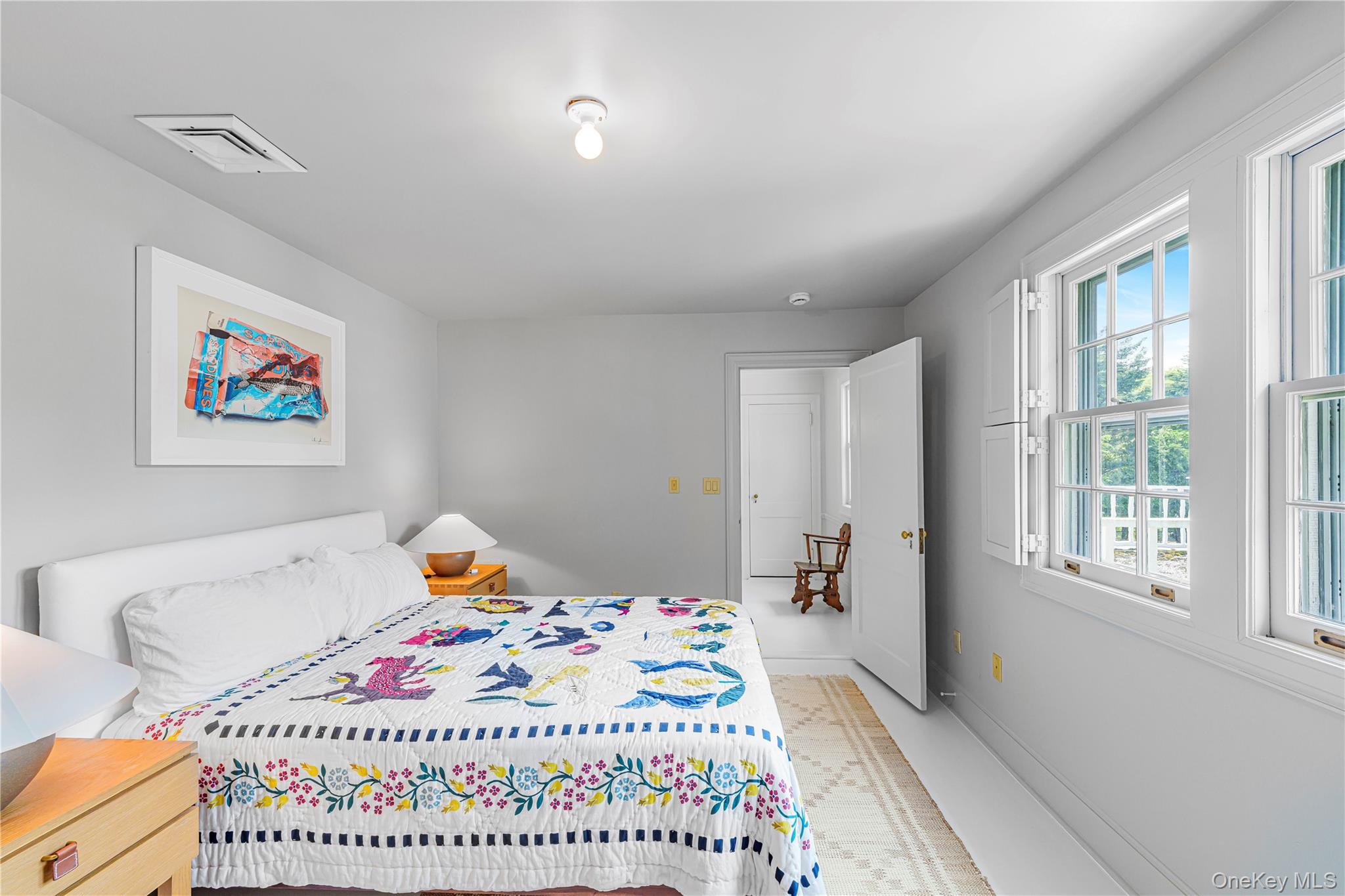 5 Thorn Hedge Road Bellport, NY 11713 - Photo 30 of 42 a bedroom with a bed and a table in it