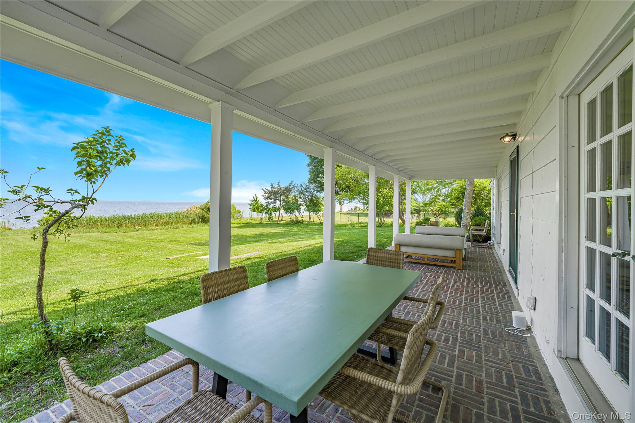 5 Thorn Hedge Road Bellport, NY 11713 - Photo 31 of 42 a view of a balcony with lake view and a floor to ceiling window