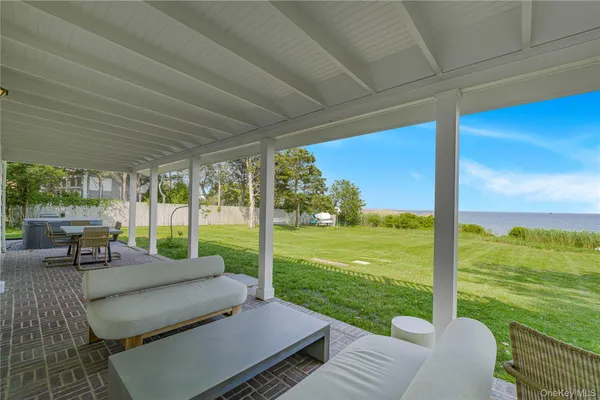 a view of a house with backyard porch and sitting area