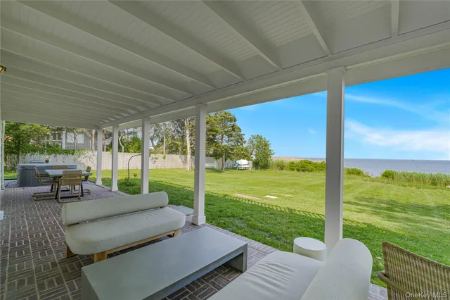 a view of a house with backyard porch and sitting area