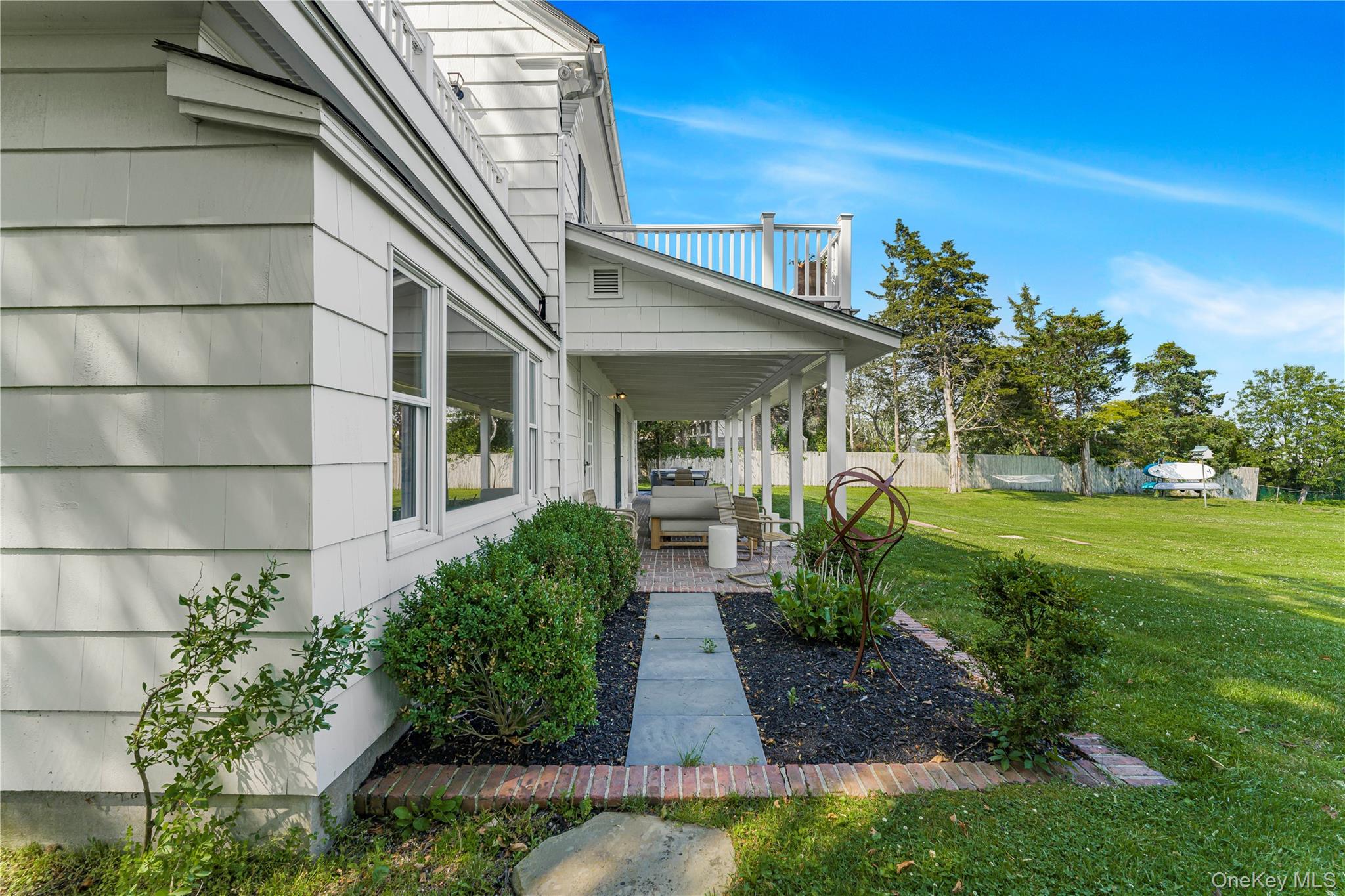 5 Thorn Hedge Road Bellport, NY 11713 - Photo 37 of 42 a front view of a house with garden
