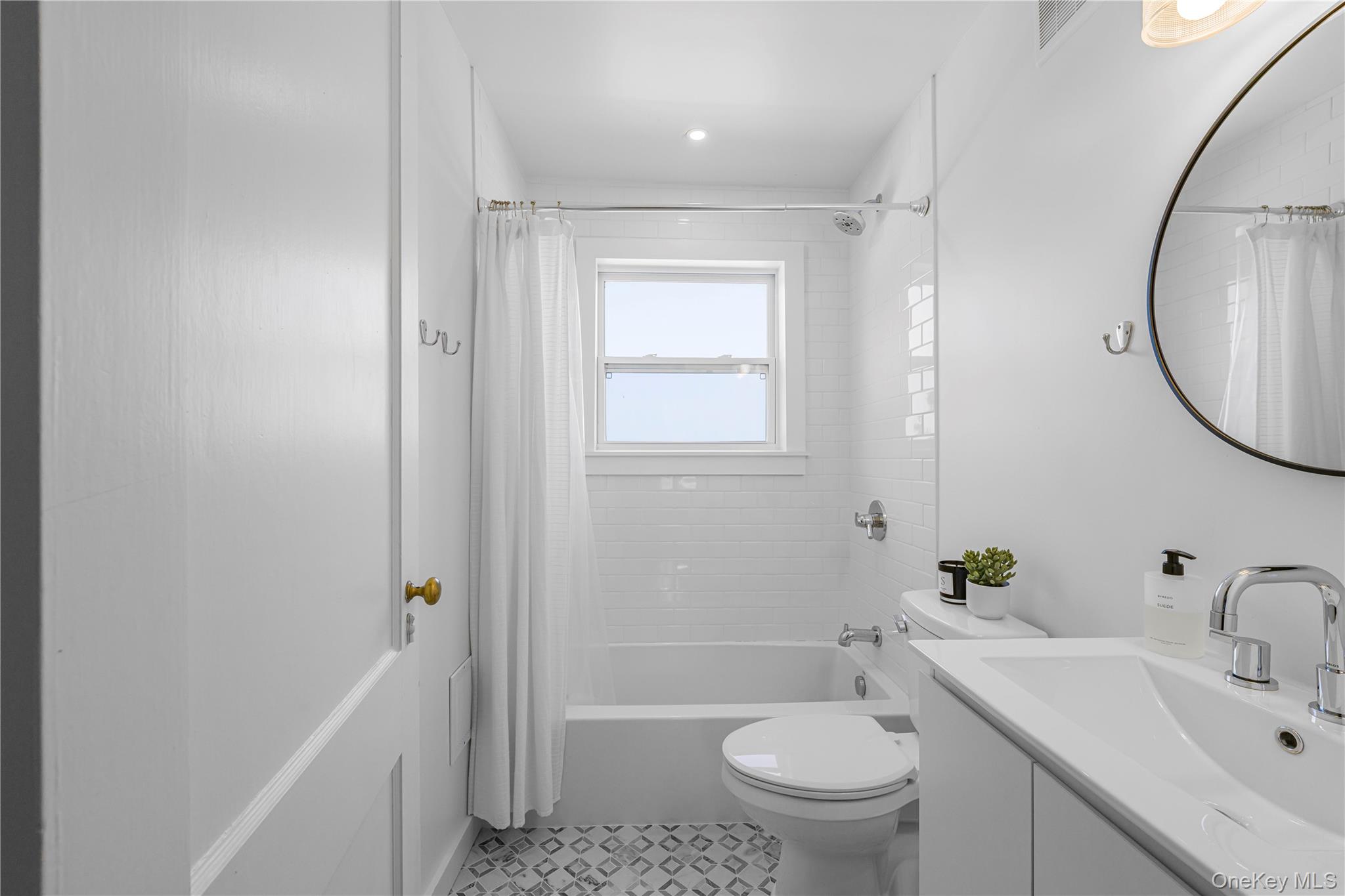 5 Thorn Hedge Road Bellport, NY 11713 - Photo 38 of 42 a bathroom with a sink toilet and shower