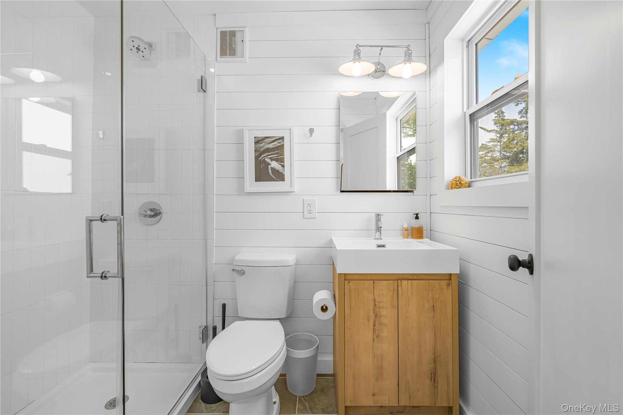 5 Thorn Hedge Road Bellport, NY 11713 - Photo 39 of 42 a bathroom with a toilet sink vanity and mirror