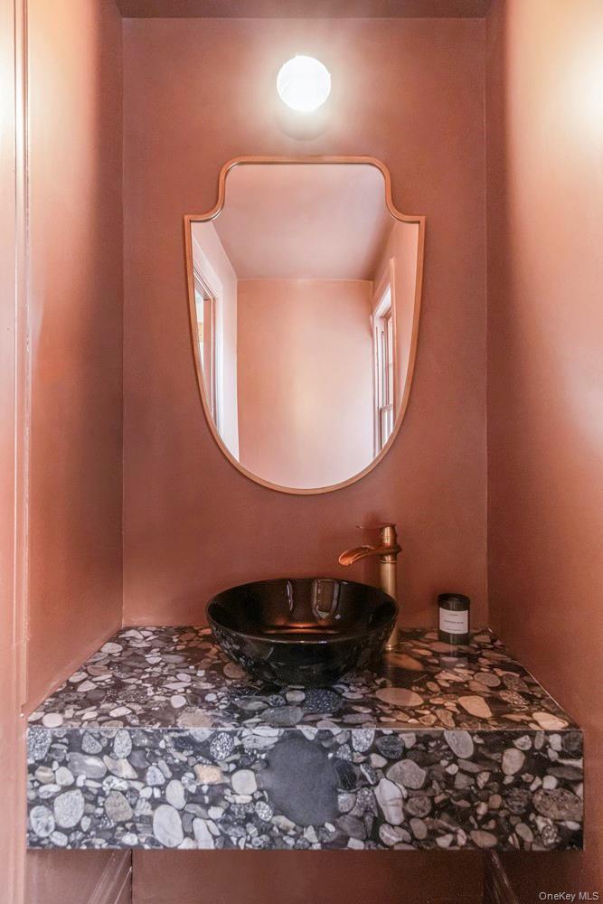 5 Thorn Hedge Road Bellport, NY 11713 - Photo 40 of 42 a bathroom with a sink and a mirror