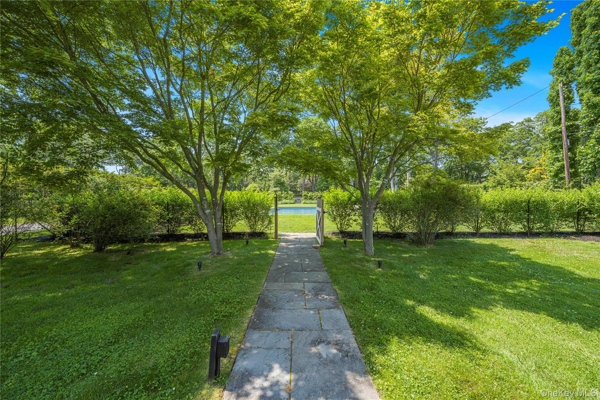 5 Thorn Hedge Road Bellport, NY 11713 - Photo 4 of 42 a front view of a house with a garden